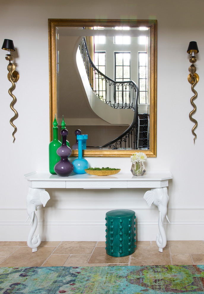 Photo of an eclectic entryway in Denver with white walls and beige floor.