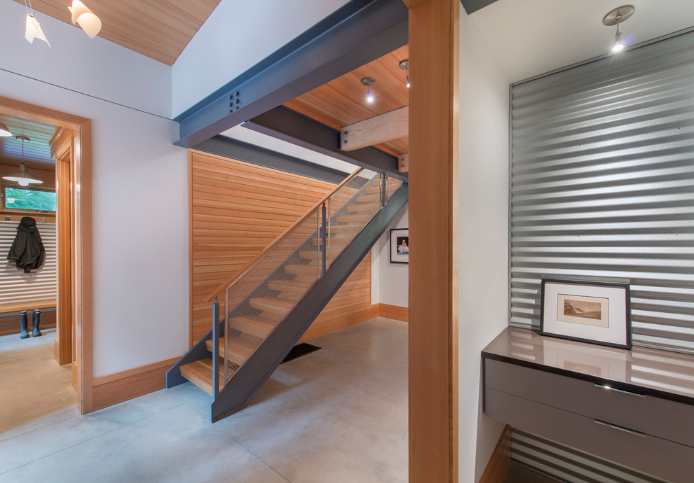 Example of a mid-sized minimalist concrete floor hallway design in Burlington with white walls