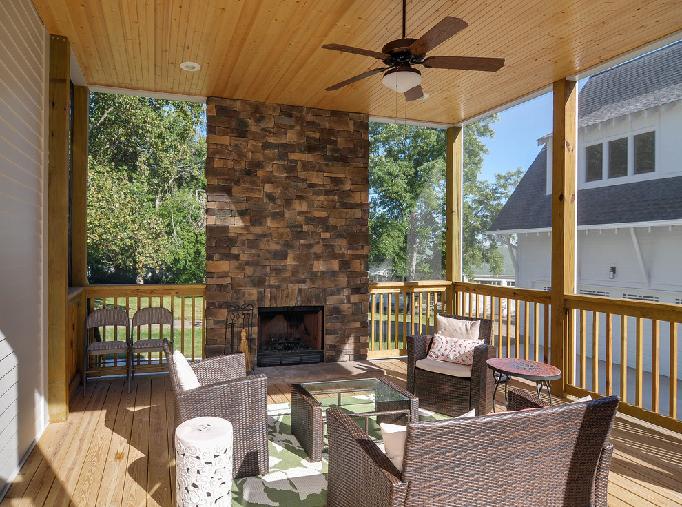 Inspiration for a large timeless screened-in back porch remodel in Nashville with a roof extension