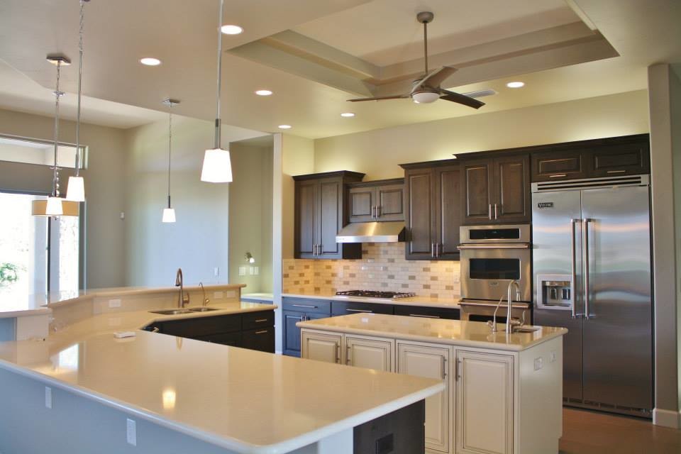 Large transitional u-shaped porcelain tile eat-in kitchen photo in Phoenix with an undermount sink, raised-panel cabinets, dark wood cabinets, quartz countertops, beige backsplash, stone tile backsplash, stainless steel appliances and an island