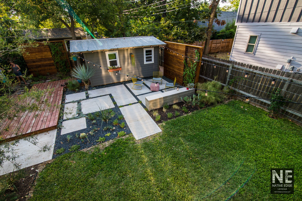 This is an example of a mid-sized country backyard patio in Austin with a vertical garden, concrete pavers and no cover.