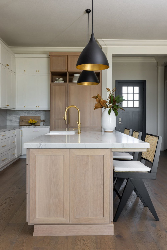 Inspiration for a large modern l-shaped open plan kitchen in Sacramento with a farmhouse sink, shaker cabinets, white cabinets, quartzite benchtops, grey splashback, panelled appliances, with island, brown floor and grey benchtop.