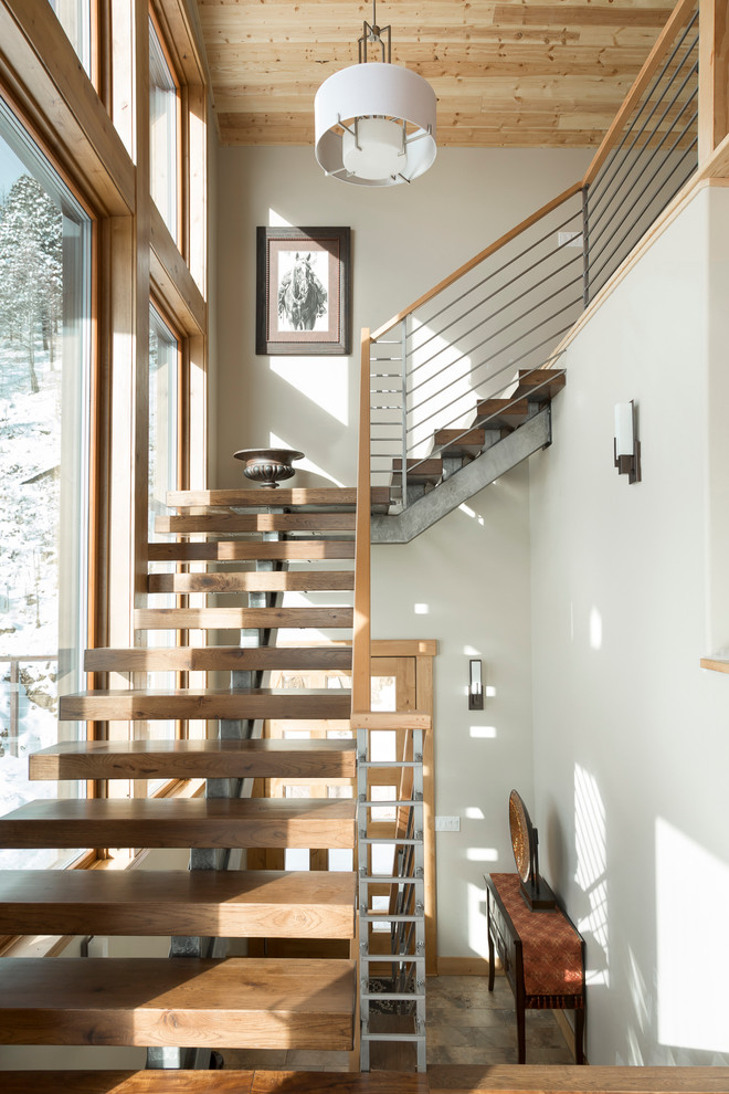 Example of a mountain style wooden l-shaped open staircase design in Denver with white walls