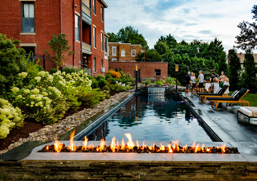 Backyard stone and rectangular hot tub photo