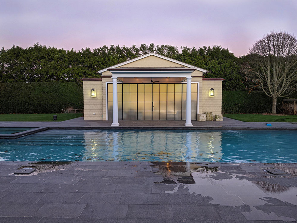 Inspiration for a large contemporary back custom shaped swimming pool in New York with a pool house.