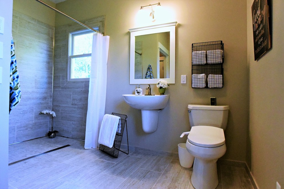 Design ideas for a mid-sized transitional bathroom in Grand Rapids with white cabinets, a curbless shower, a bidet, gray tile, ceramic tile, beige walls, ceramic floors, a wall-mount sink, grey floor, a shower curtain and white benchtops.