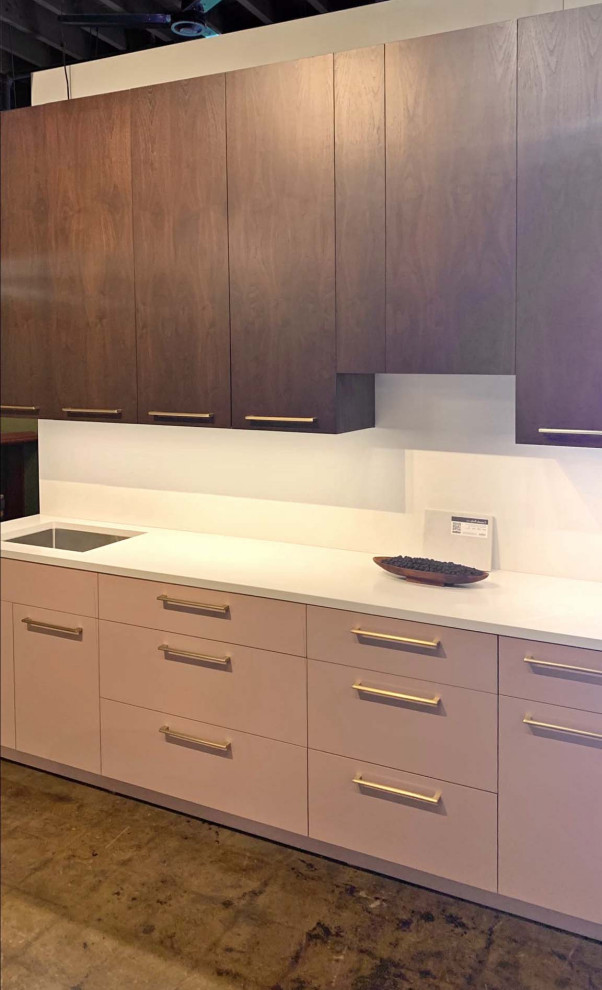 Photo of a mid-sized transitional single-wall separate kitchen in New York with flat-panel cabinets, pink cabinets, quartz benchtops, white splashback, engineered quartz splashback, with island and white benchtop.