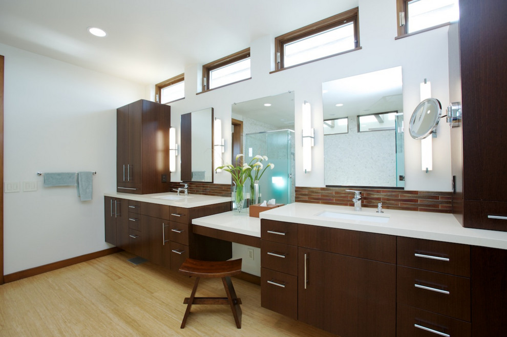 Inspiration for a modern master bathroom in Orange County with flat-panel cabinets, dark wood cabinets, brown tile, glass tile, white walls, bamboo floors and engineered quartz benchtops.