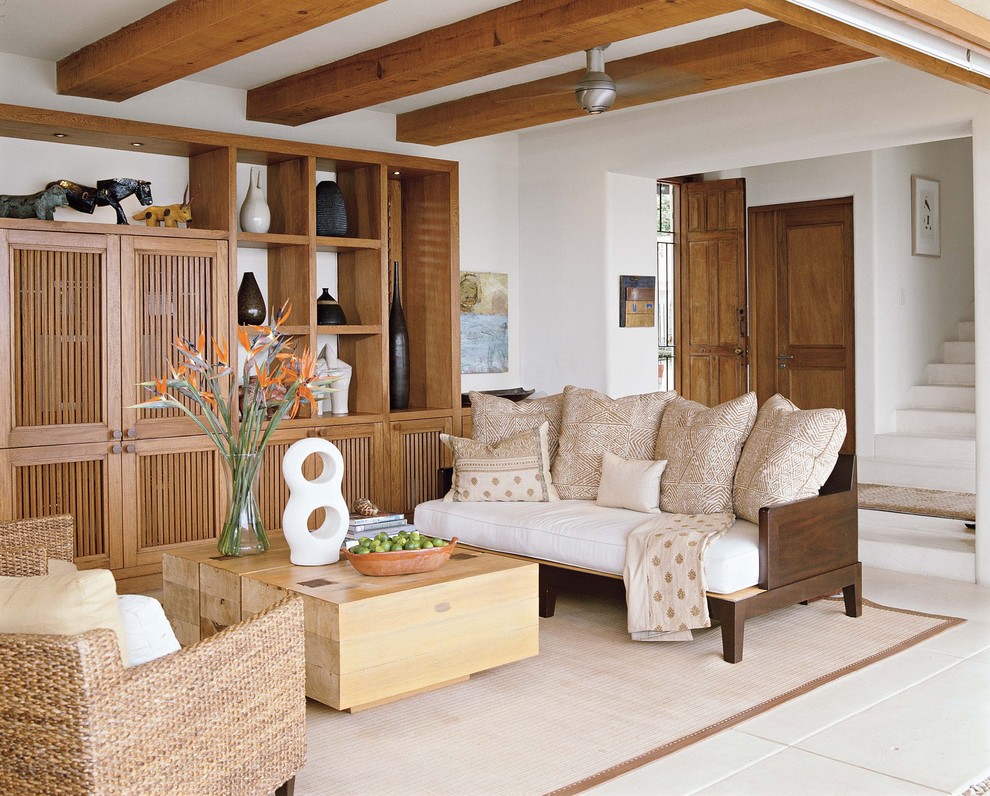 Photo of an expansive tropical open concept living room in Other with white walls and a built-in media wall.