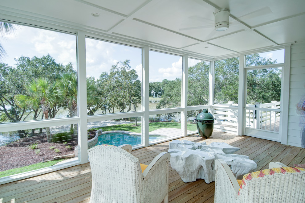 Inspiration for a mid-sized beach style backyard screened-in verandah in Charleston with decking and a roof extension.