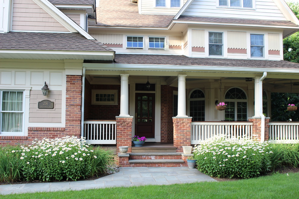 Inspiration for a large timeless stone front porch remodel in New York with a roof extension