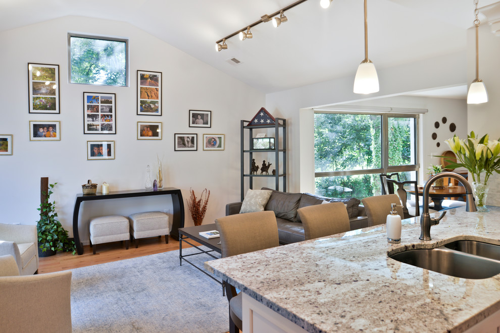 Example of a huge minimalist u-shaped light wood floor and brown floor eat-in kitchen design in DC Metro with a double-bowl sink, white cabinets, gray backsplash, stainless steel appliances, a peninsula and gray countertops