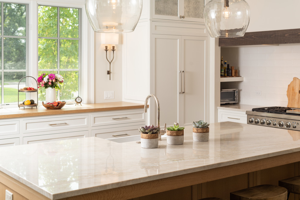 Kitchen - large traditional dark wood floor and brown floor kitchen idea in Chicago with white cabinets, paneled appliances, an island and shaker cabinets