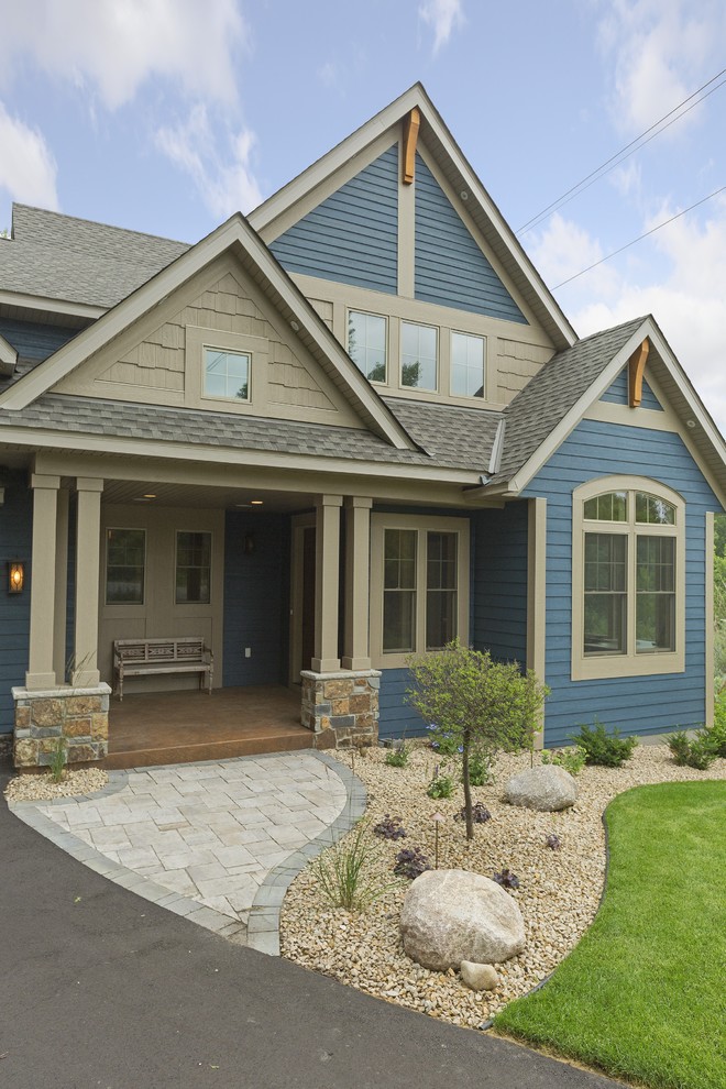 Inspiration for a large traditional two-storey blue exterior in Minneapolis with wood siding and a gable roof.