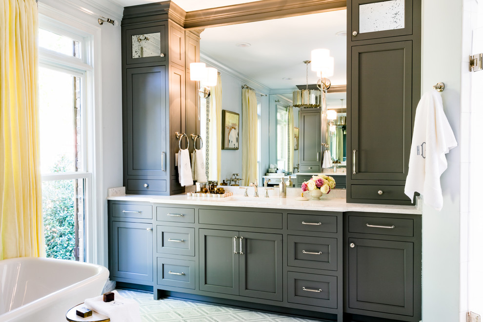 Large transitional master freestanding bathtub photo with shaker cabinets, gray cabinets, white walls, an undermount sink, quartz countertops and white countertops
