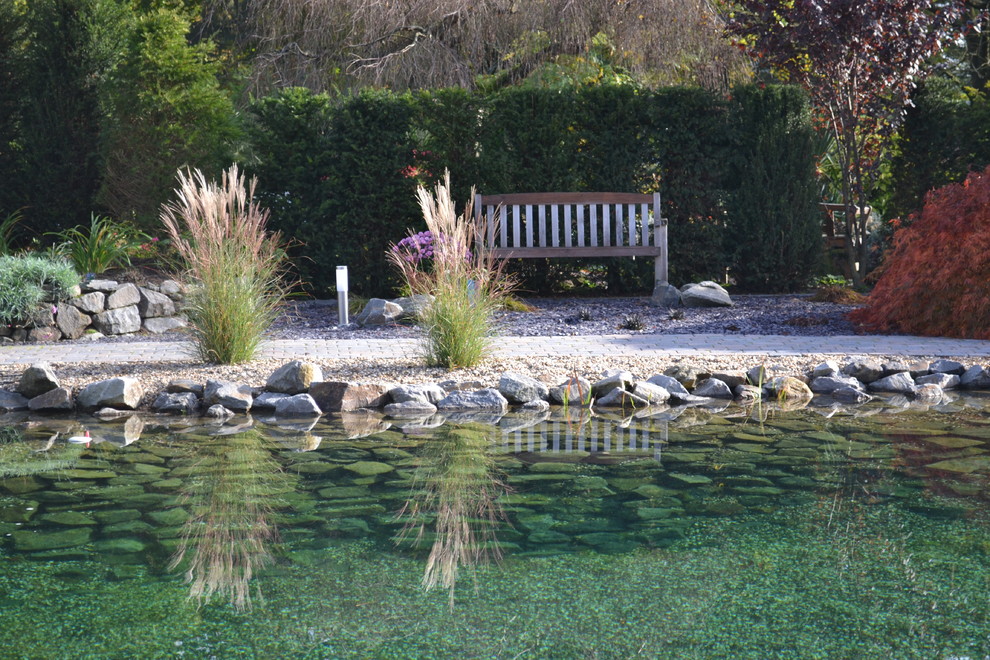 This is an example of a country full sun garden for fall in Other with a garden path and natural stone pavers.