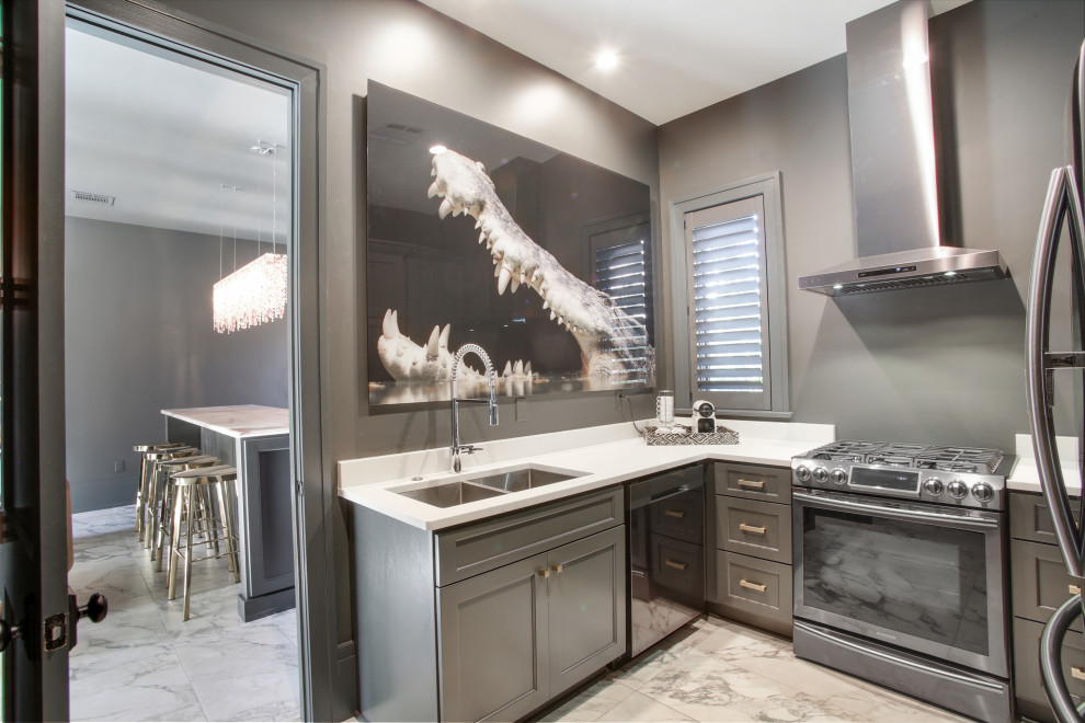 This is an example of a small transitional single-wall kitchen in New Orleans with a double-bowl sink, shaker cabinets, white cabinets, wood benchtops, grey splashback, ceramic splashback, stainless steel appliances, marble floors, with island, white floor, white benchtop and vaulted.