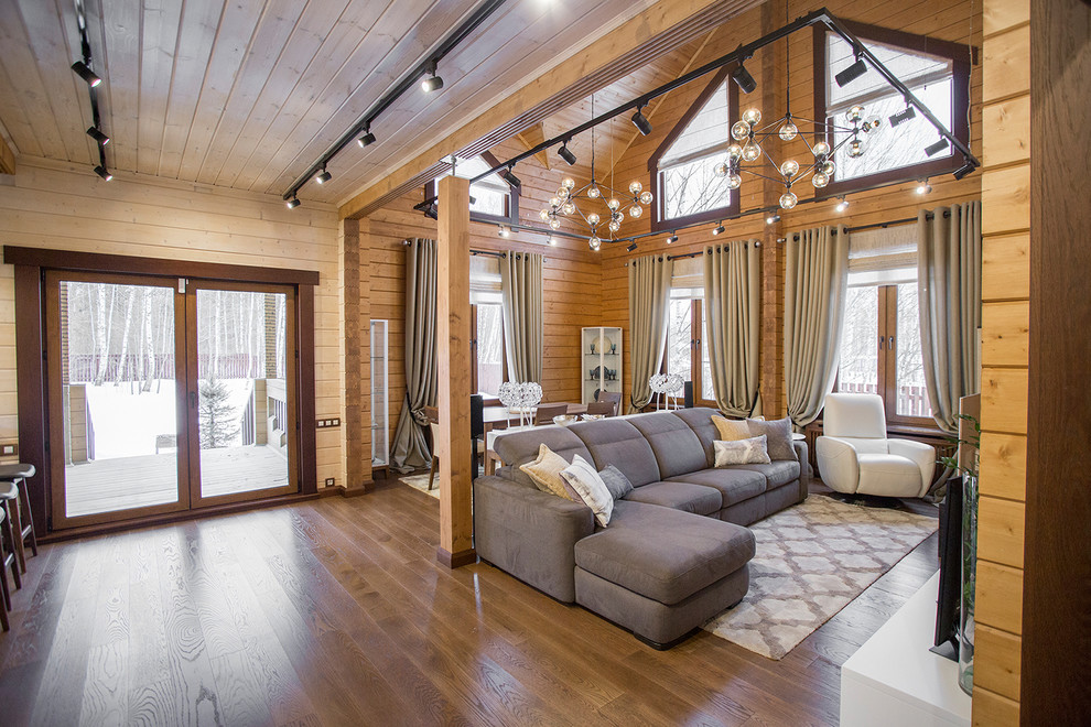 Photo of a mid-sized contemporary formal open concept living room in Moscow with brown walls, medium hardwood floors, a standard fireplace and brown floor.