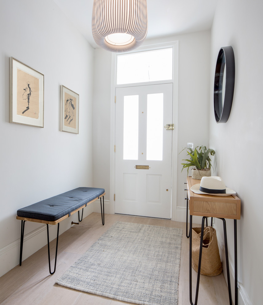 Photo of a mid-sized contemporary entry hall in London with grey walls, light hardwood floors, a single front door, a white front door and beige floor.