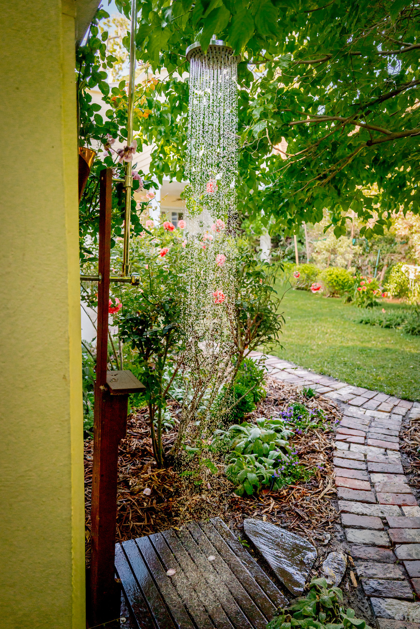Outdoor Shower Along Curved Brick Garden Path