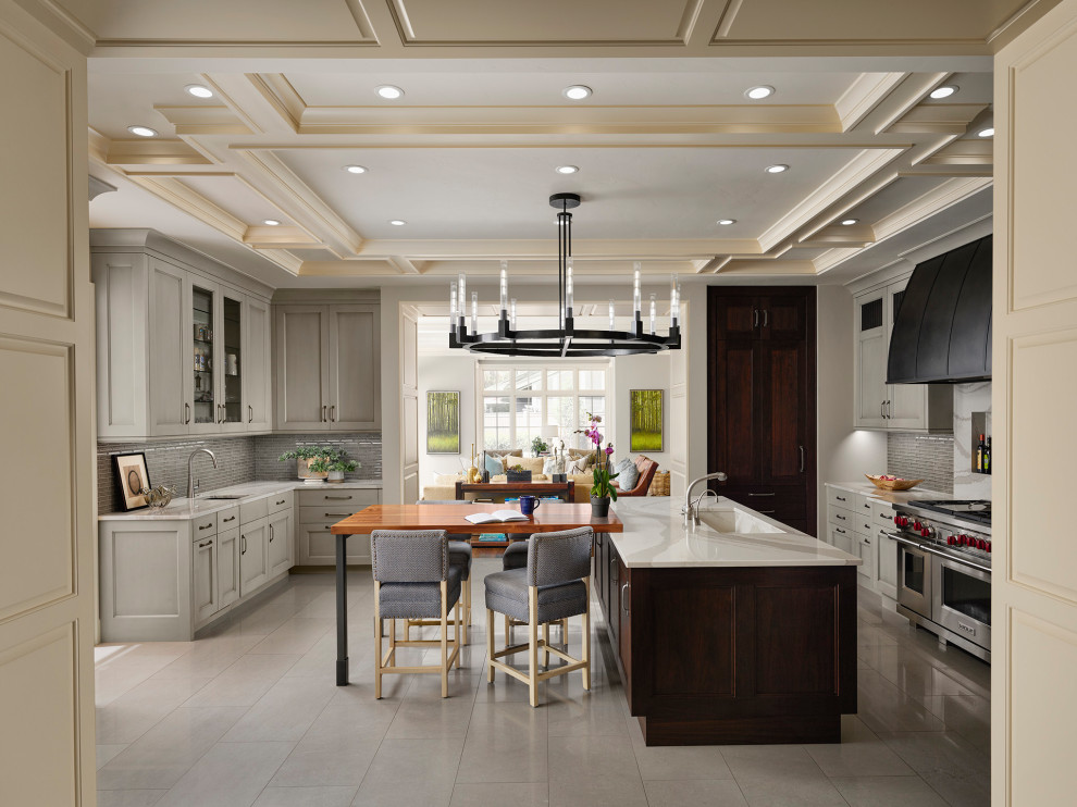 Example of a transitional kitchen design in Denver with dark wood cabinets and an island
