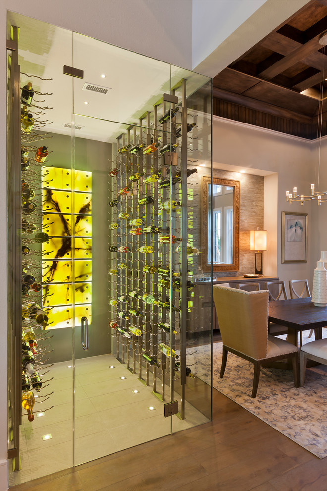 This is an example of a large transitional wine cellar in Tampa with porcelain floors, storage racks and beige floor.