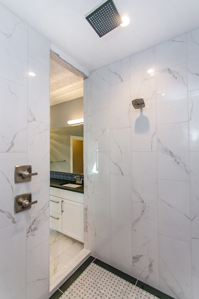 Inspiration for a mid-sized modern master bathroom in Seattle with shaker cabinets, white cabinets, a drop-in tub, a double shower, a two-piece toilet, black tile, porcelain tile, grey walls, marble floors, an undermount sink, engineered quartz benchtops, white floor and an open shower.