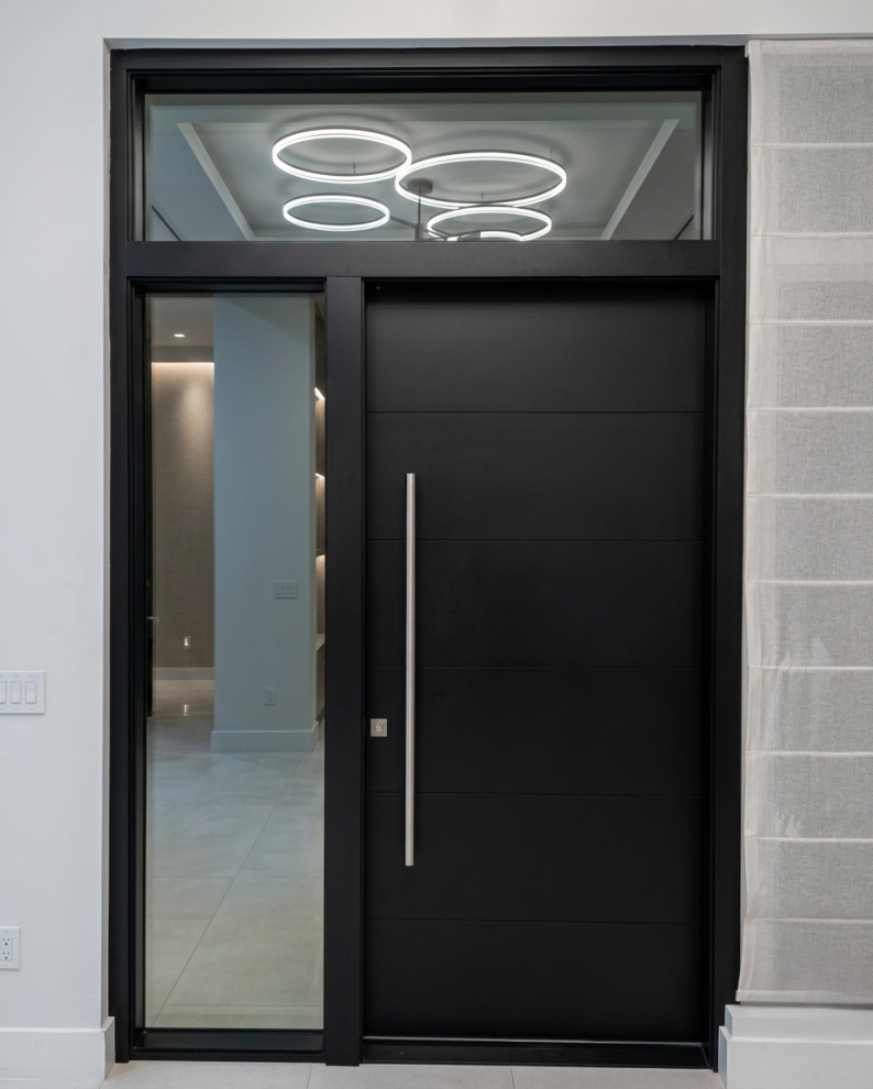 Inspiration for a large front door remodel in Miami with a black front door