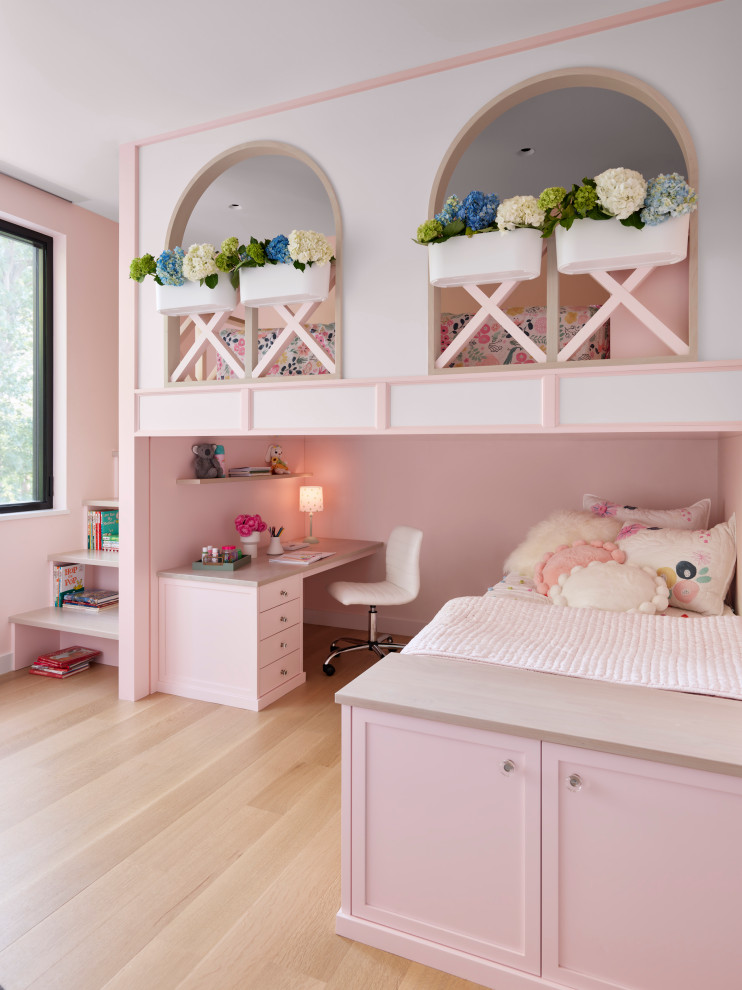 Photo of a transitional kids' bedroom for kids 4-10 years old and girls in Chicago with pink walls, light hardwood floors and beige floor.