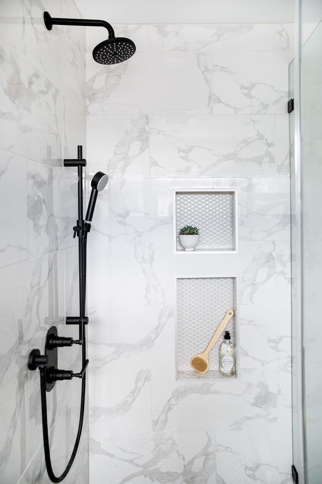 Photo of a large transitional master bathroom in Calgary with flat-panel cabinets, medium wood cabinets, a freestanding tub, a corner shower, gray tile, marble, white walls, porcelain floors, an undermount sink, engineered quartz benchtops, grey floor, a hinged shower door and white benchtops.