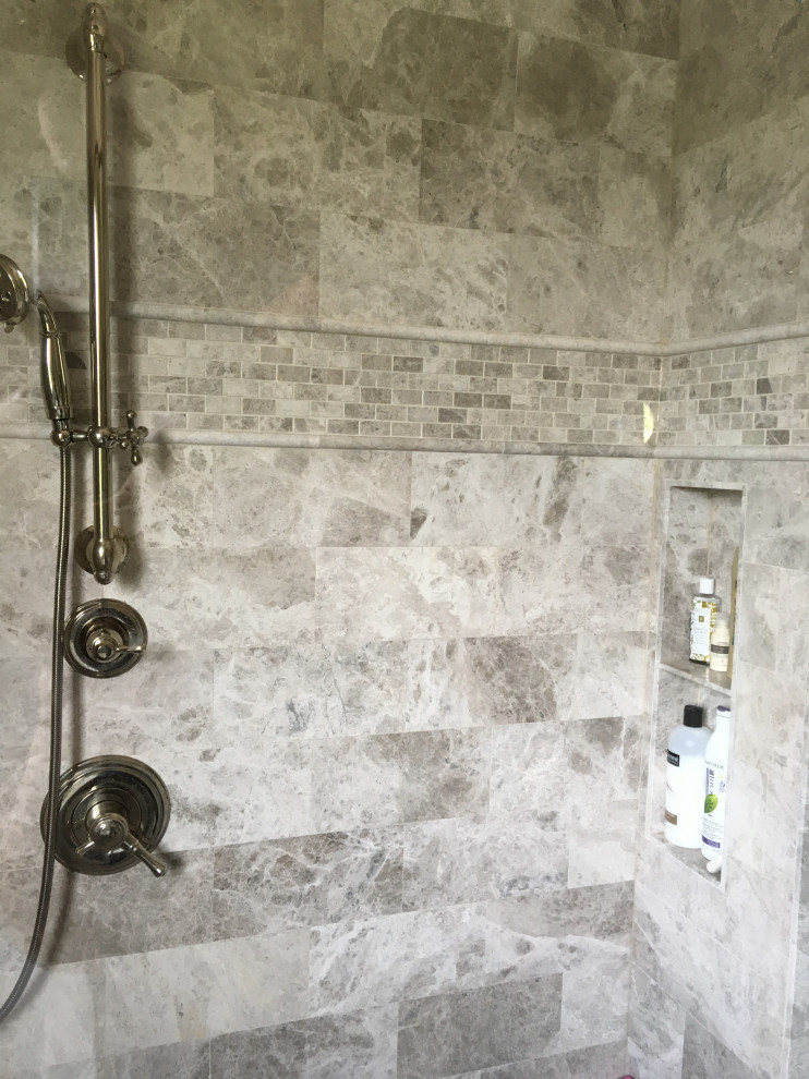 This is an example of a mid-sized traditional master bathroom in Atlanta with shaker cabinets, white cabinets, a freestanding tub, a corner shower, a one-piece toilet, gray tile, stone tile, brown walls, marble floors, an undermount sink, quartzite benchtops, grey floor, an open shower, white benchtops, a shower seat, a double vanity, a built-in vanity, coffered and panelled walls.