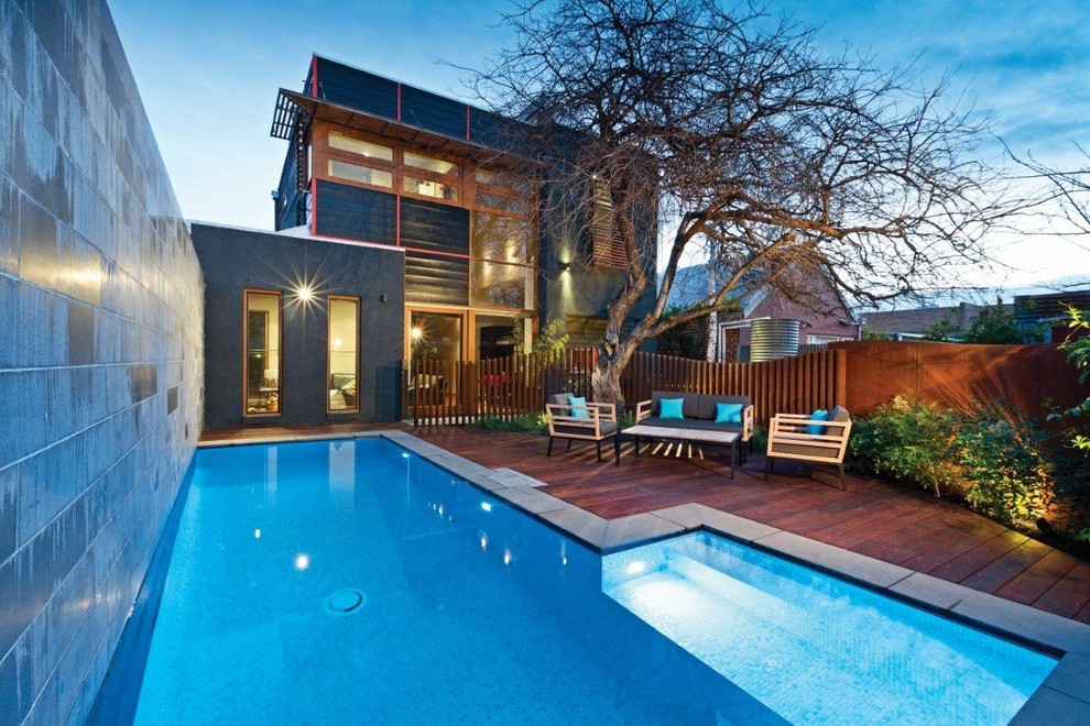Photo of a contemporary rectangular lap pool in Sydney with decking.