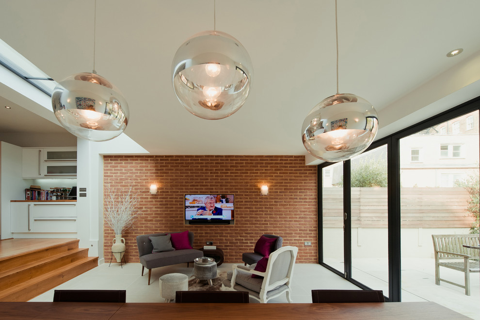 This is an example of a large modern open plan living room with ceramic flooring and a concealed tv.