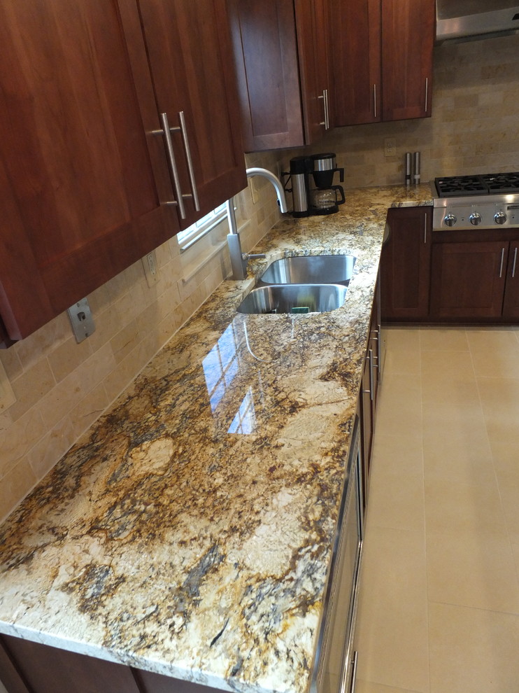 Eat-in kitchen - mid-sized transitional l-shaped ceramic tile eat-in kitchen idea in Columbus with an undermount sink, shaker cabinets, brown cabinets, granite countertops, beige backsplash, ceramic backsplash, stainless steel appliances and an island