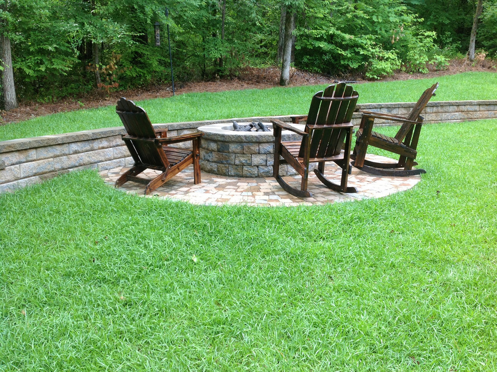 Mid-sized arts and crafts backyard patio in Atlanta with a fire feature, brick pavers and no cover.
