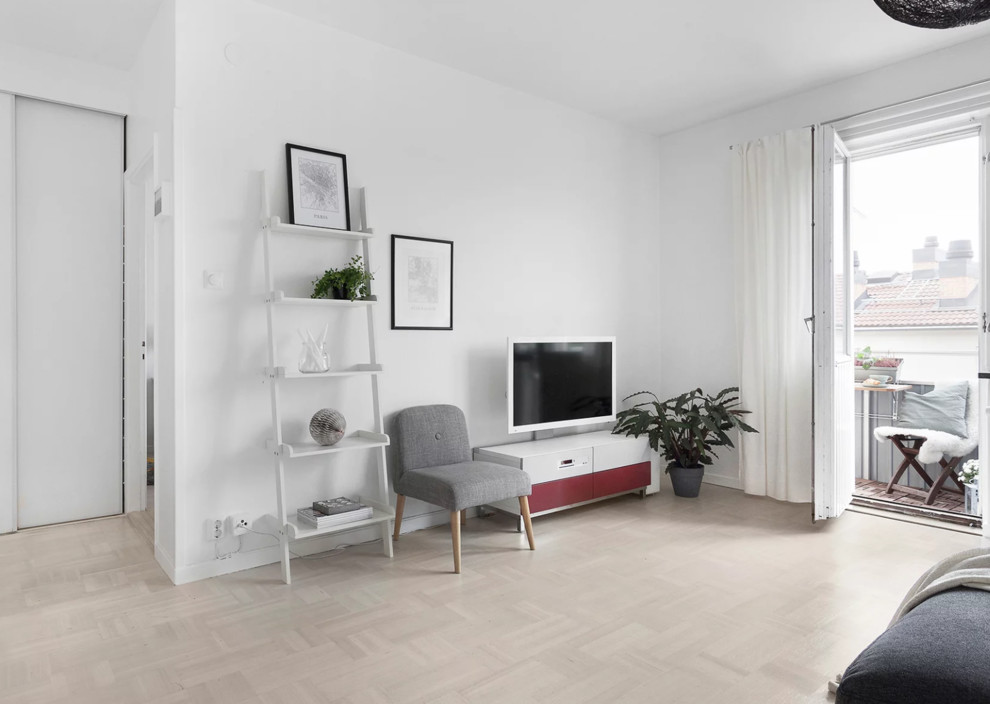 This is an example of a mid-sized scandinavian enclosed living room in Stockholm with white walls, light hardwood floors, a freestanding tv and beige floor.