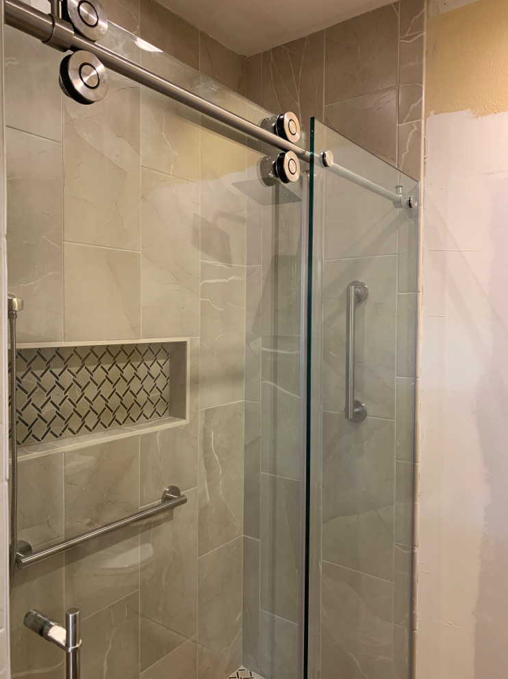 Photo of a mid-sized traditional master bathroom in Austin with raised-panel cabinets, dark wood cabinets, an alcove shower, a two-piece toilet, brown tile, porcelain tile, yellow walls, terra-cotta floors, an undermount sink, granite benchtops, orange floor, a sliding shower screen, beige benchtops, a shower seat, a double vanity and a built-in vanity.