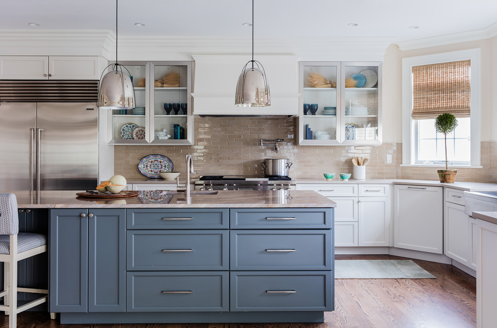 Example of a transitional medium tone wood floor eat-in kitchen design in Boston with a farmhouse sink, glass-front cabinets, beige backsplash, stainless steel appliances, an island and ceramic backsplash