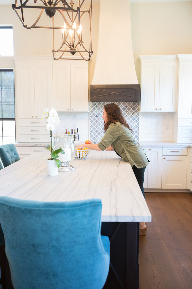 Open concept kitchen - large transitional l-shaped medium tone wood floor open concept kitchen idea in Phoenix with an undermount sink, shaker cabinets, white cabinets, quartzite countertops, marble backsplash, stainless steel appliances and an island