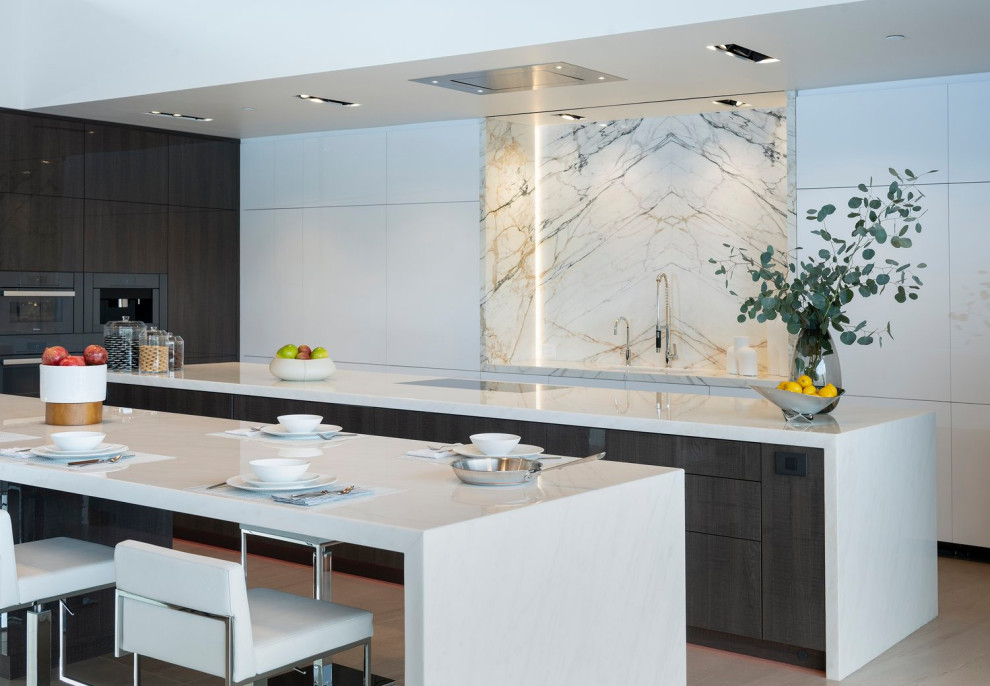 Design ideas for an expansive modern l-shaped kitchen/diner in Los Angeles with white cabinets, white splashback, marble splashback, porcelain flooring, multiple islands, white floors, white worktops and a drop ceiling.