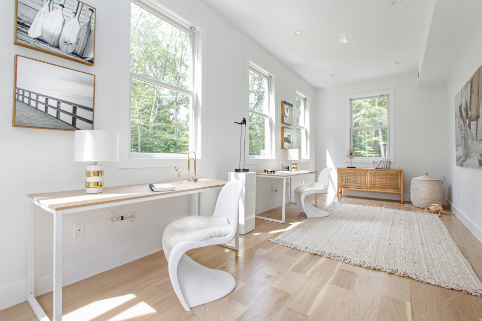 Inspiration for a large contemporary freestanding desk light wood floor home office remodel in New York with white walls