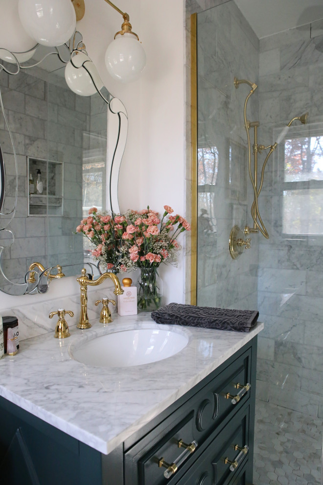 Photo of a traditional bathroom in Los Angeles with blue cabinets, an alcove shower, white walls, marble floors, an undermount sink, marble benchtops, a hinged shower door, a single vanity and a freestanding vanity.