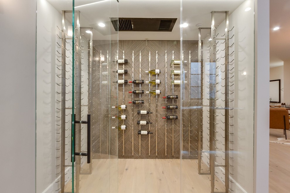 Design ideas for a contemporary wine cellar in San Francisco with light hardwood floors, storage racks and beige floor.