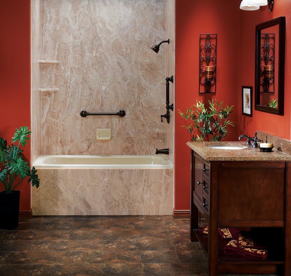 Design ideas for a mid-sized mediterranean 3/4 bathroom in Dallas with shaker cabinets, dark wood cabinets, an alcove tub, a shower/bathtub combo, brown tile, stone slab, red walls, an undermount sink, granite benchtops, brown floor, brown benchtops, a single vanity and a freestanding vanity.