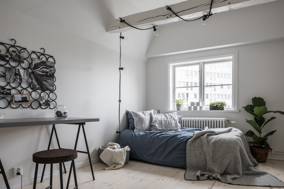 Mid-sized scandinavian bedroom in Stockholm with white walls, light hardwood floors and no fireplace.