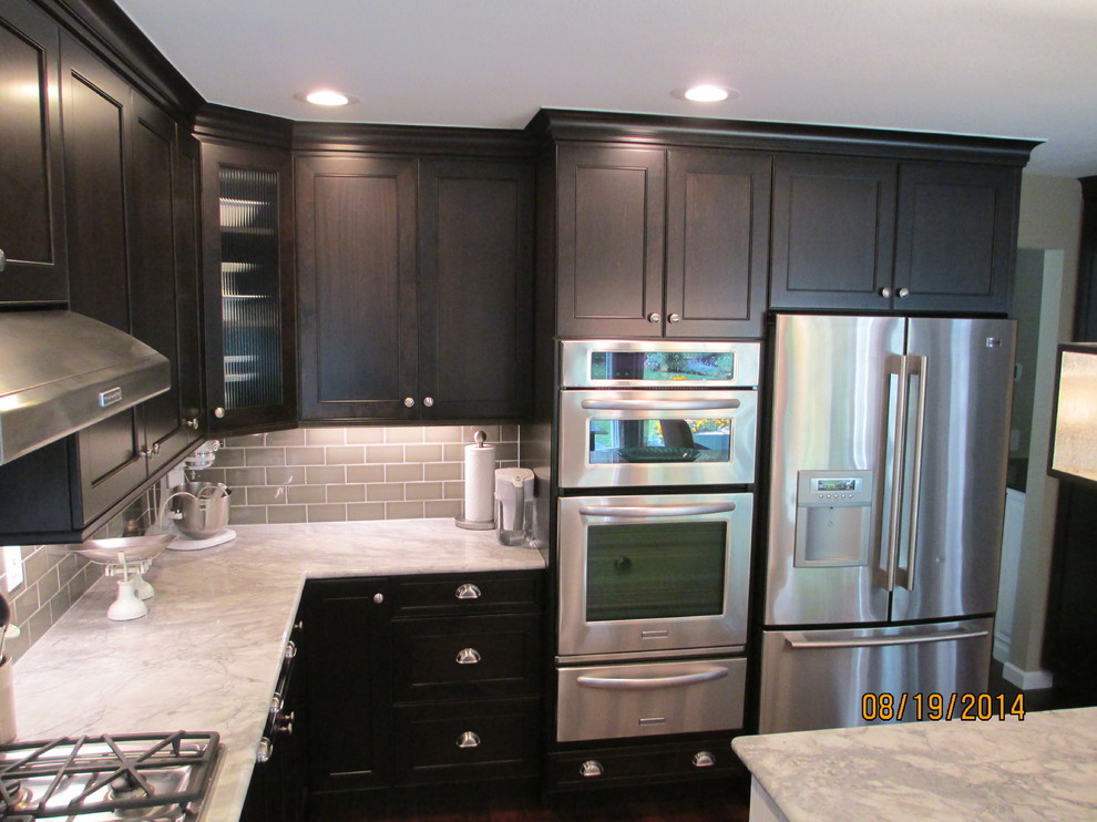 Mid-sized transitional u-shaped dark wood floor kitchen photo in Denver with an undermount sink, shaker cabinets, dark wood cabinets, marble countertops, gray backsplash, subway tile backsplash, stainless steel appliances and an island