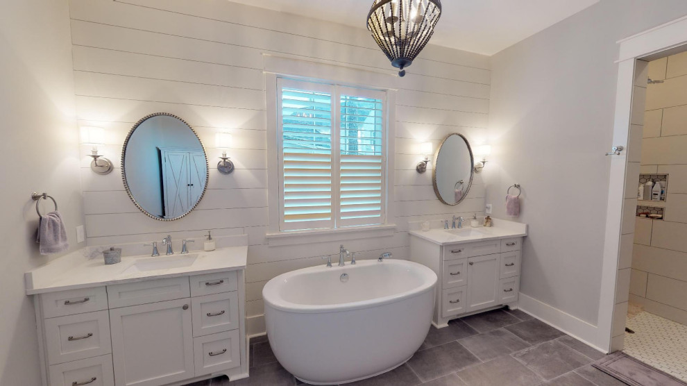 Design ideas for a mid-sized country master bathroom in Other with shaker cabinets, white cabinets, a freestanding tub, an open shower, a one-piece toilet, grey walls, an undermount sink, engineered quartz benchtops, grey floor, an open shower and white benchtops.