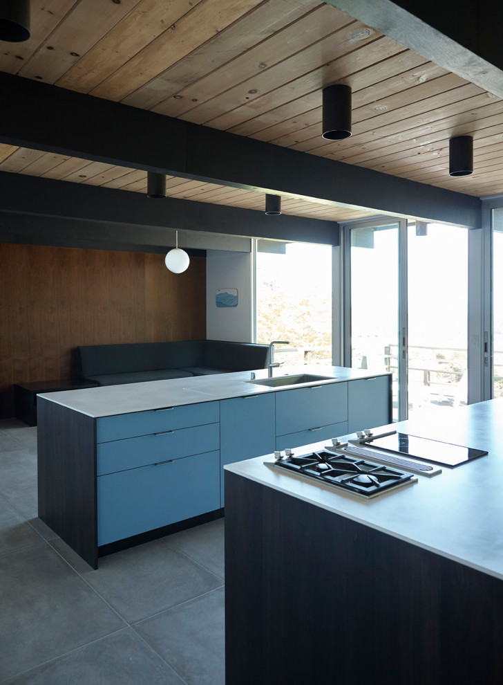 Design ideas for a mid-sized midcentury open plan kitchen in San Francisco with flat-panel cabinets, dark wood cabinets, solid surface benchtops, ceramic floors and multiple islands.