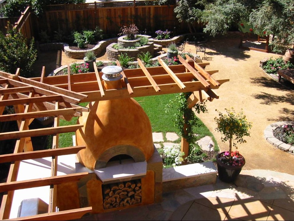 Photo of a large mediterranean backyard patio in San Francisco with an outdoor kitchen and decomposed granite.