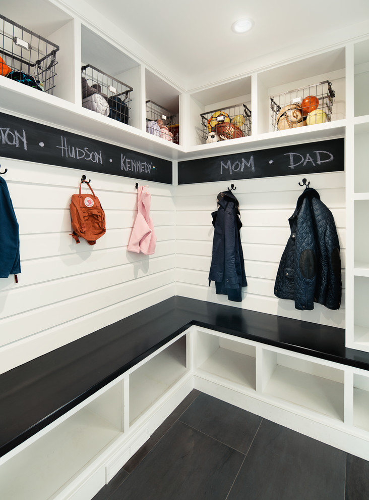 Inspiration for a mid-sized country mudroom in New York with white walls.